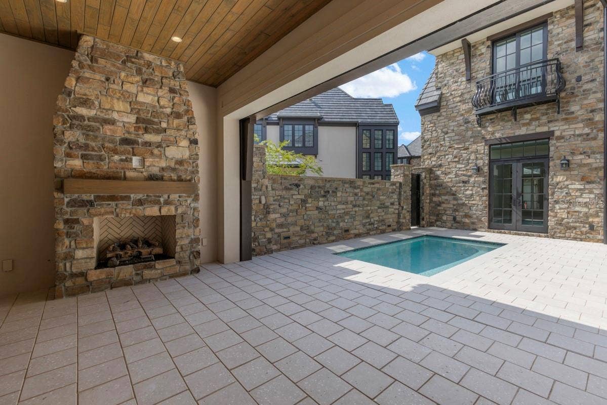 10335 WINTER SPARKLE CIRCLE, Golden Oak, FL 32836 Outdoor living area with summer kitchen and heated lounging pool