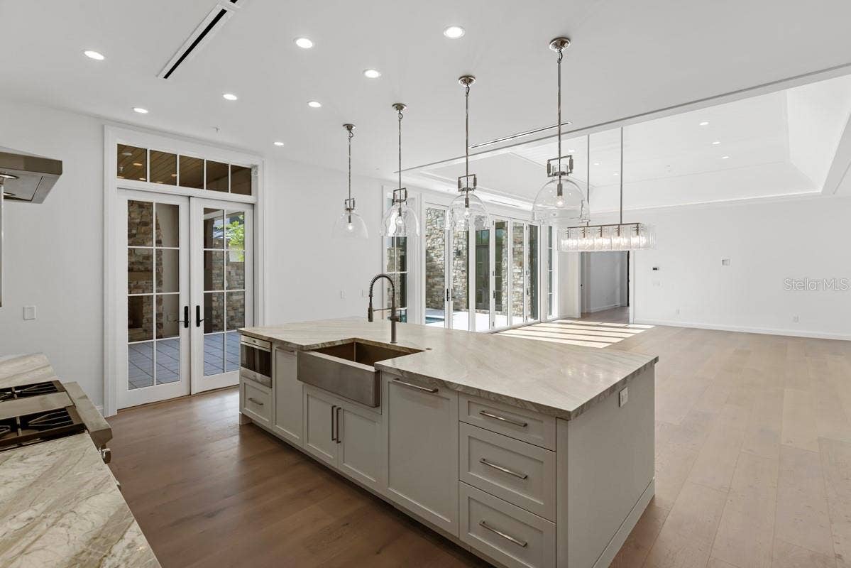 10335 WINTER SPARKLE CIRCLE, Golden Oak, FL 32836 Gourmet kitchen with frameless contemporary cabinetry and alarge prep island