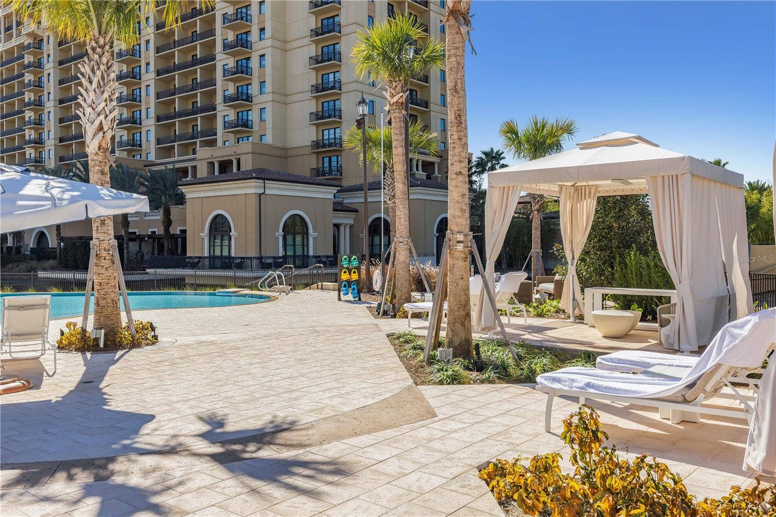 10335 WINTER SPARKLE CIRCLE, Golden Oak, FL 32836 Florian Park Amenities: Perfectly situated between the luxe residences and boutique homes will be a lakeside oasis, featuring the pool and spa, rejuvenating water features, privacy cabanas with towel service and indoor-outdoor dining areas with fire pits and lounge seating.