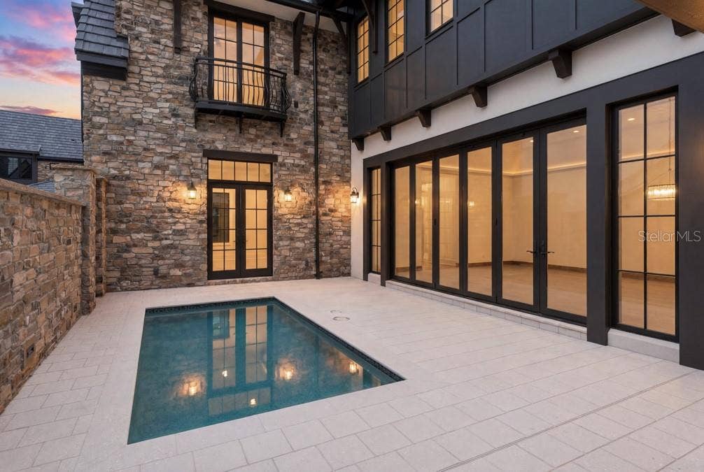 10335 WINTER SPARKLE CIRCLE, Golden Oak, FL 32836 Outdoor living area with summer kitchen and heated lounging pool