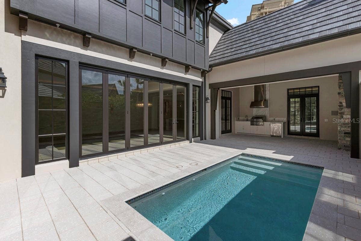 10335 WINTER SPARKLE CIRCLE, Golden Oak, FL 32836 Outdoor living area with summer kitchen and heated lounging pool