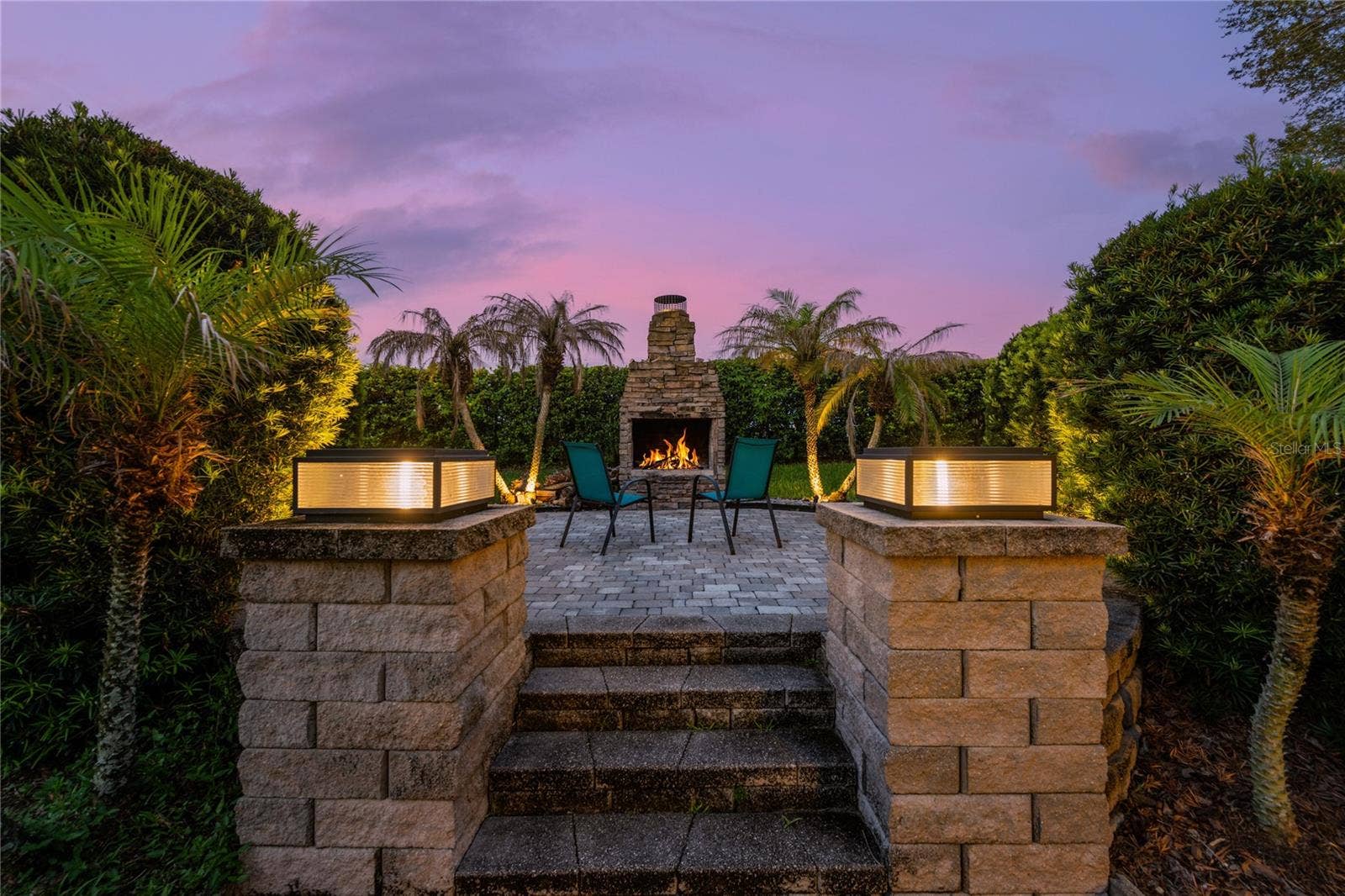 15604 GRANLUND STREET, Winter Garden, FL 34787 Backyard Retreat- Beautifully designed raised paver gathering space anchored by a grand wood-burning fireplace.