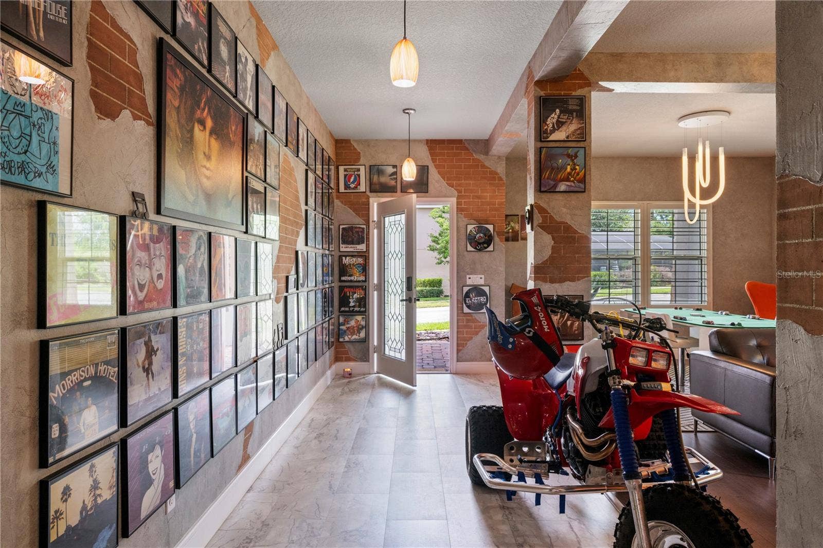 15604 GRANLUND STREET, Winter Garden, FL 34787 Welcoming foyer, formal living and dining spaces feature custom faux brick and textured wall finishes created by an artist who contributed to the Wizarding World attractions at Universal Orlando.