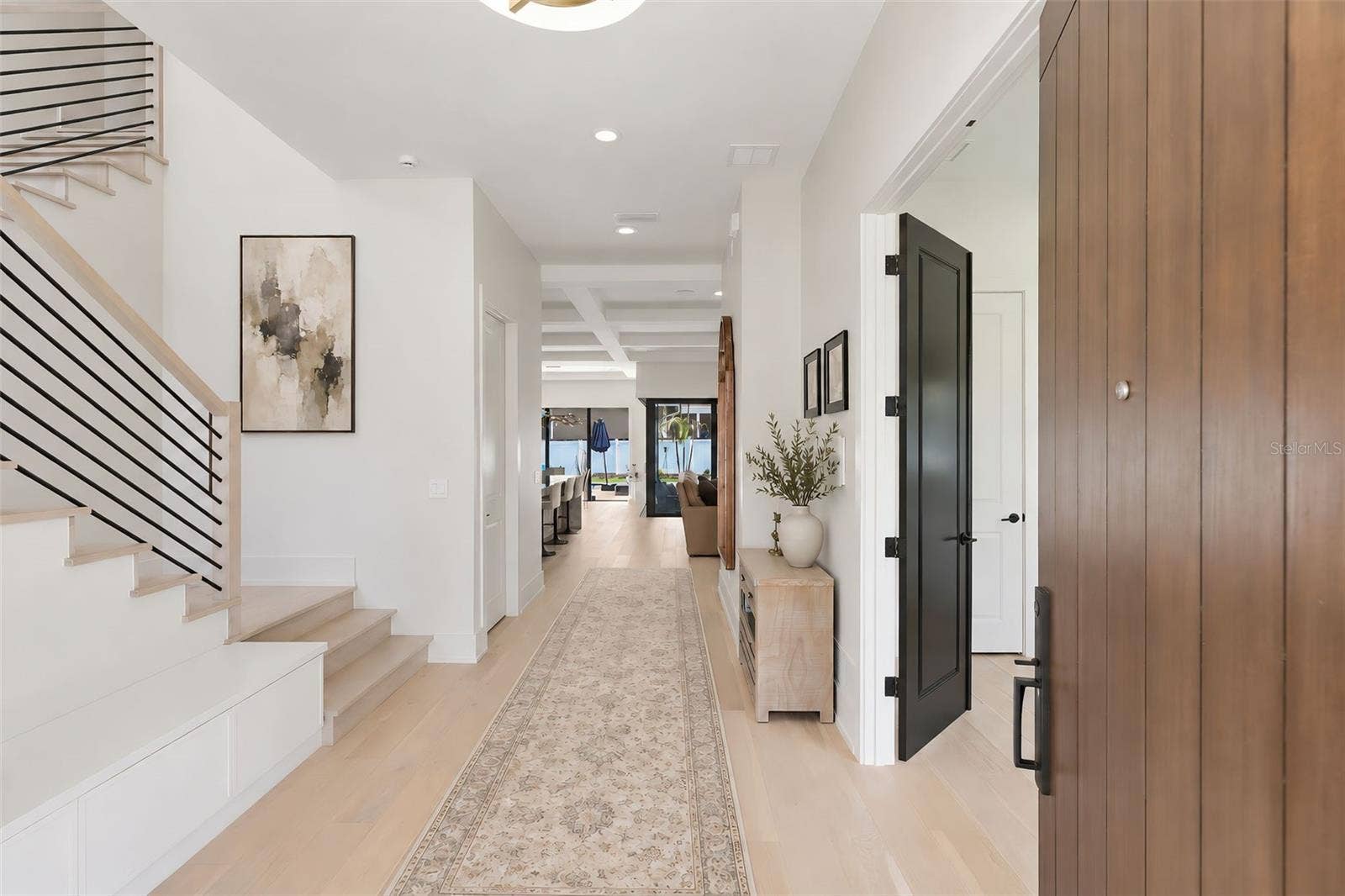 809 E CHURCH STREET, Orlando, FL 32801 Entryway into the home with built in storage bench to the left and guest bedroom with double doors to the right