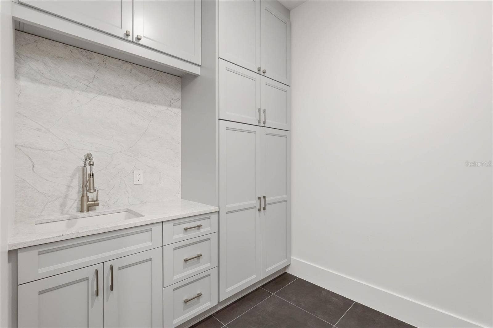 809 E CHURCH STREET, Orlando, FL 32801 Upstairs laundry room with custom cabinets & utility sink