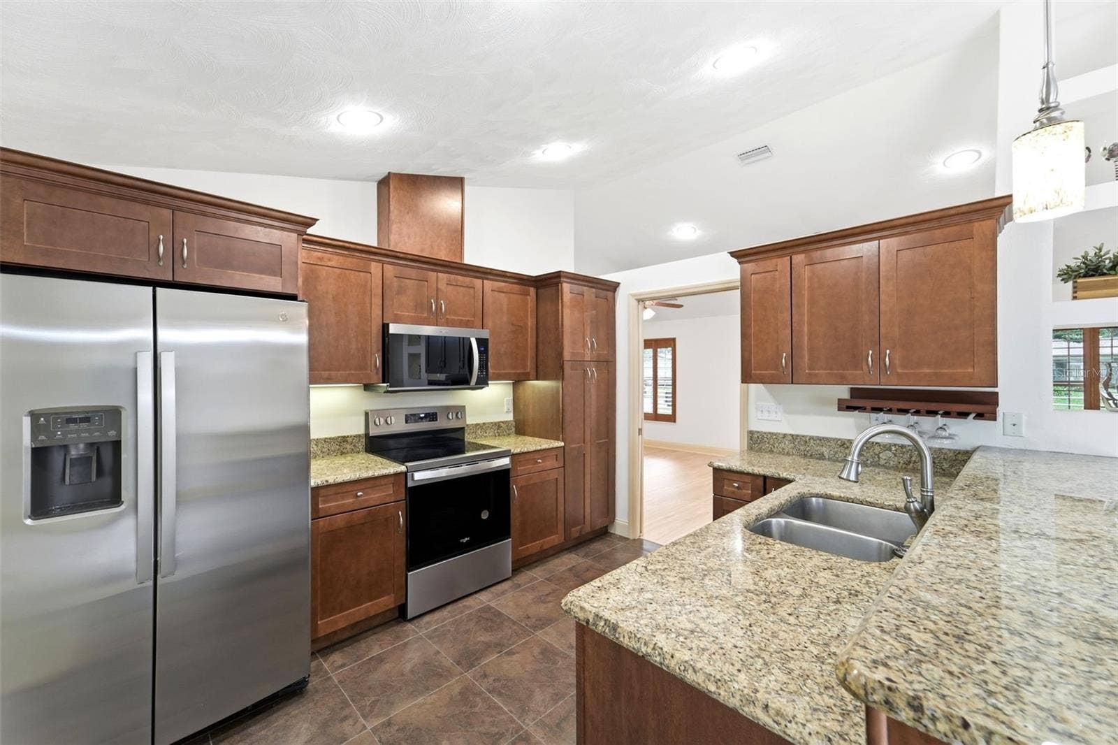 59 CRESTWOOD CIRCLE, Ormond Beach, FL 32174 The heart of the home features generous workspace and seamless flow into the living areas.