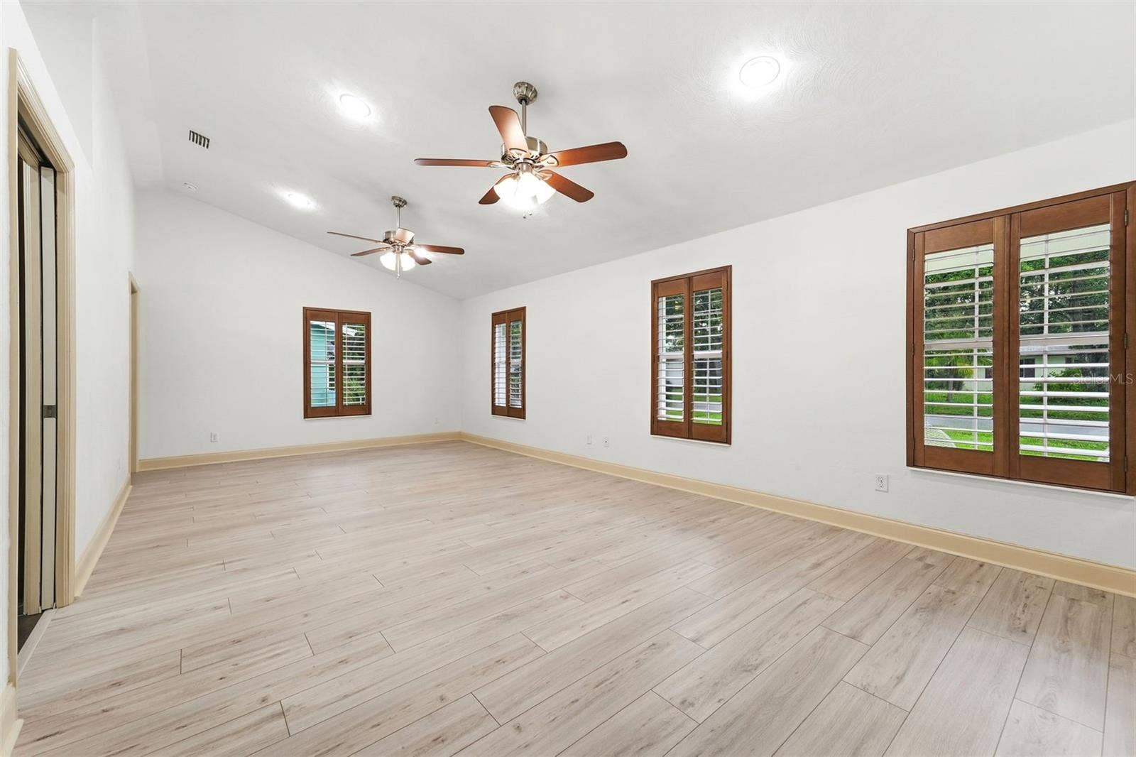 59 CRESTWOOD CIRCLE, Ormond Beach, FL 32174 Vaulted ceilings and abundant natural light create an open, airy atmosphere.