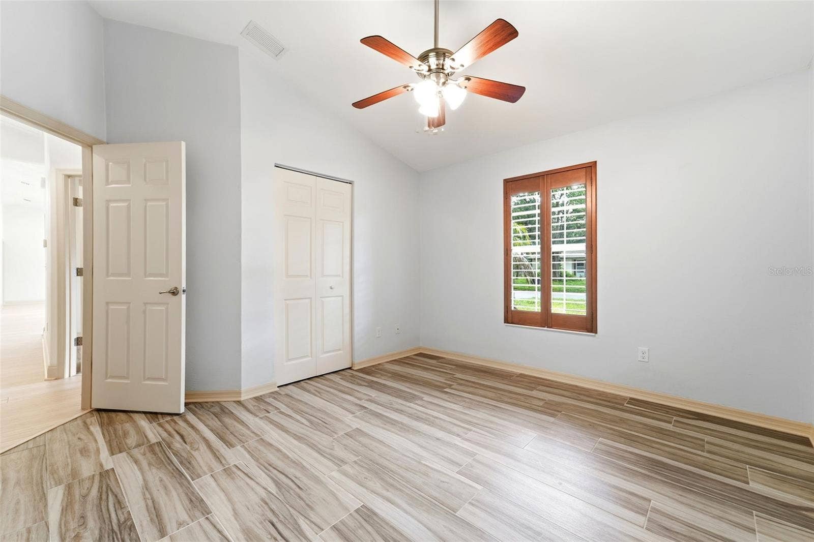 59 CRESTWOOD CIRCLE, Ormond Beach, FL 32174 Bedroom two with built in closet and plantation shutters.