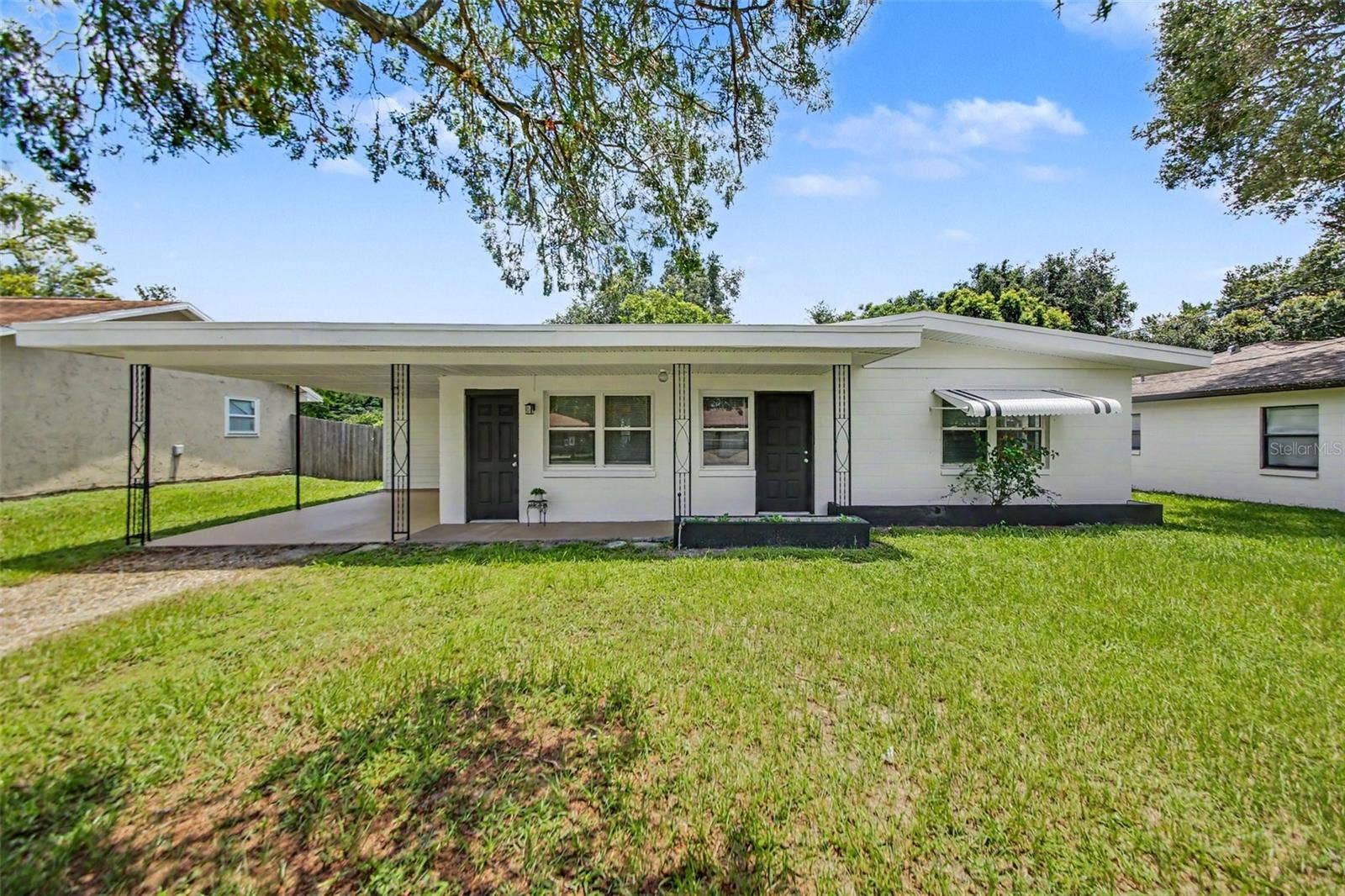 4965 ORANGE AVENUE, Winter Park, FL 32792 Attractive front yard featuring established planters, a defined walkway, and refreshed curb appeal.