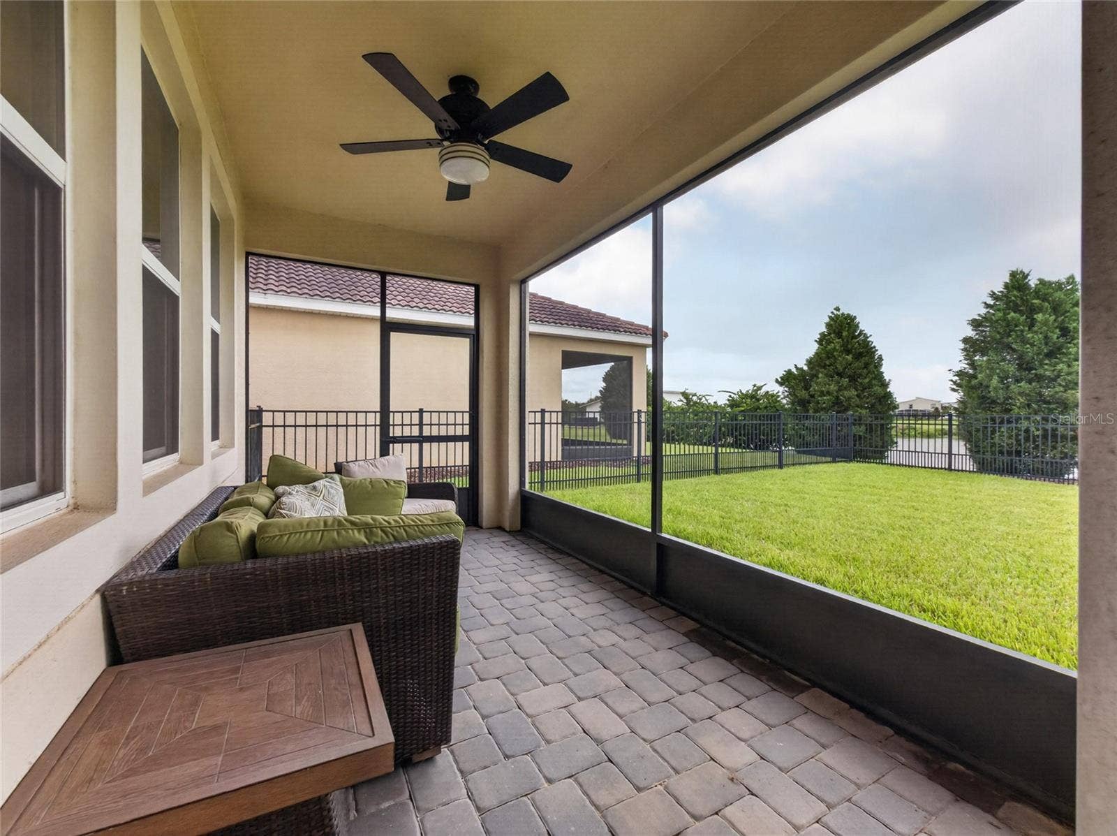 8813 BETH PAGE LANE, Davenport, FL 33896 Screened-in pavered lanai overlooking a fully fenced backyard with beautiful golf course viewsthe perfect spot to relax and enjoy Florida living.