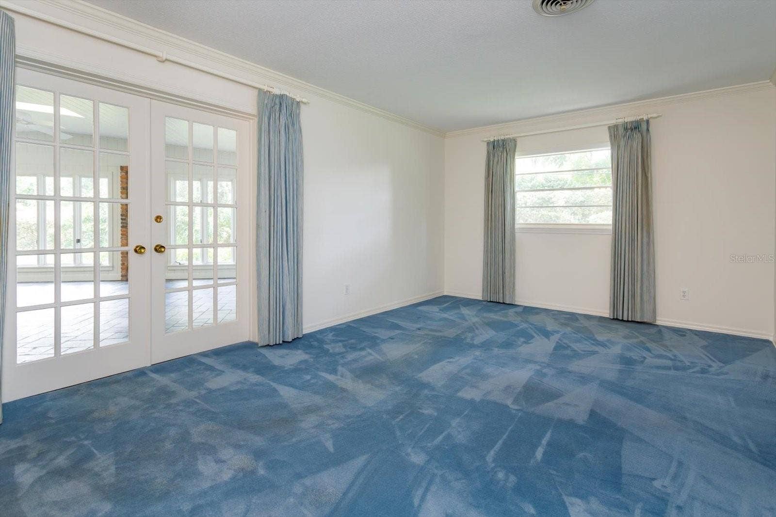 5019 GRAN LAC AVENUE, Orlando, FL 32812 Primary Bedroom has french doors to Florida Room