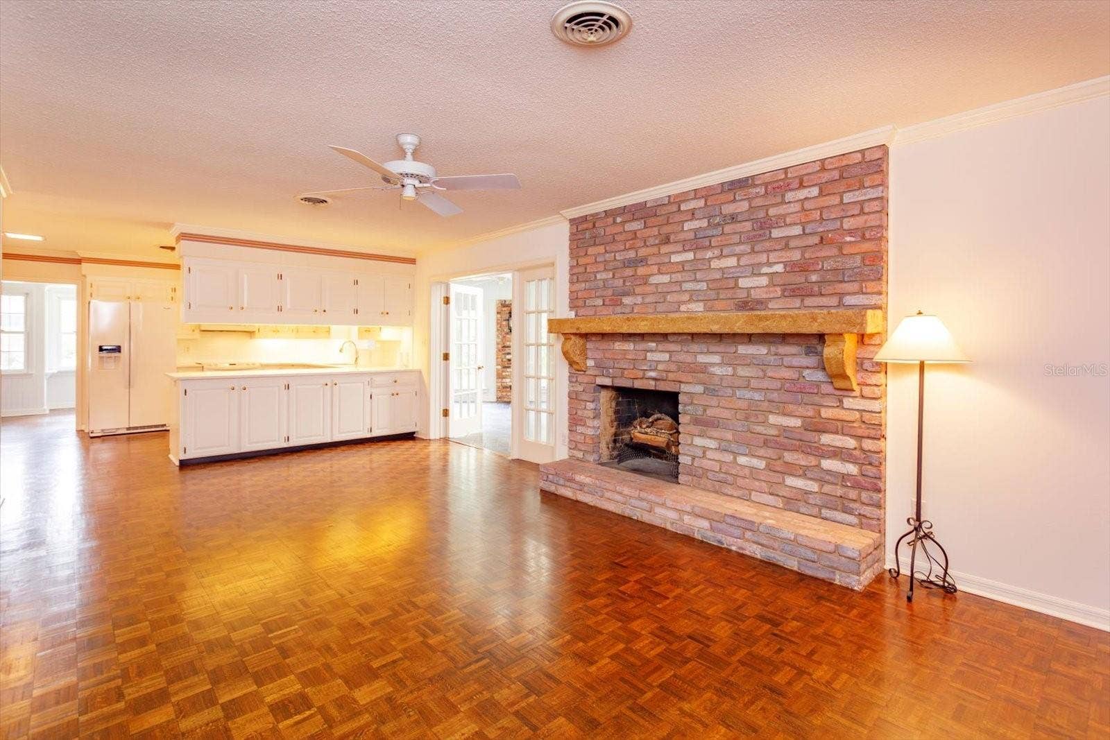 5019 GRAN LAC AVENUE, Orlando, FL 32812 Family Room is open to Kitchen and has custom mantle over brick fire place