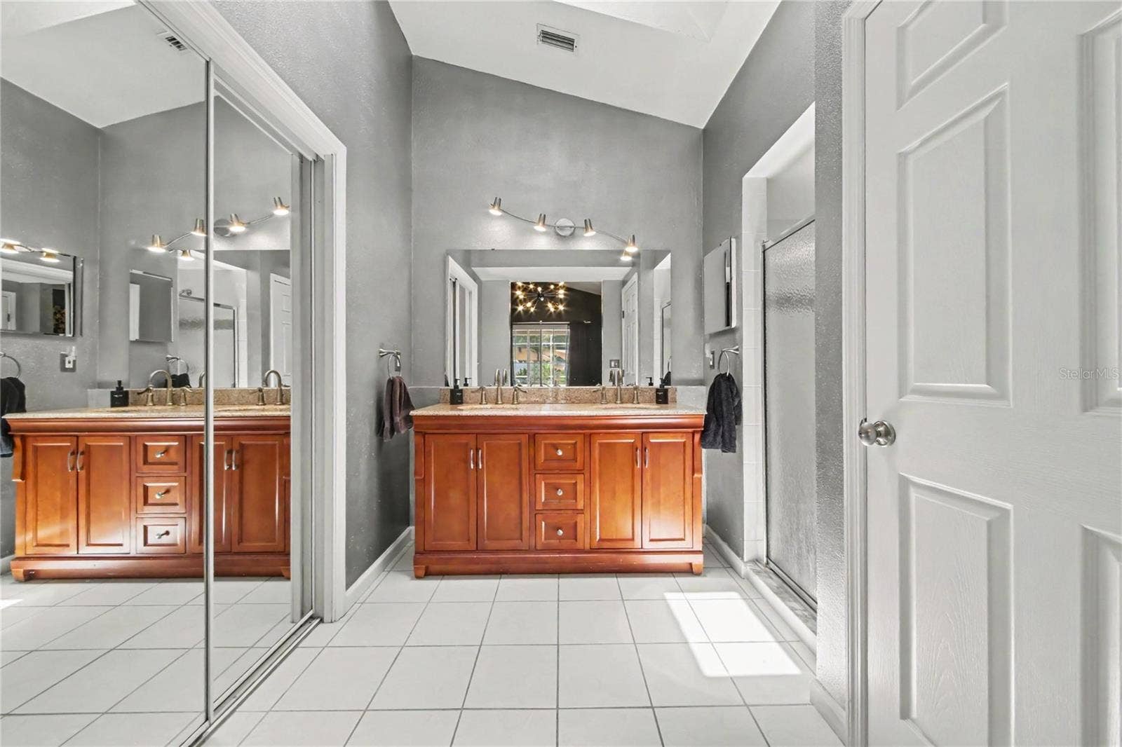 2013 BEAVER CREEK DRIVE, Port Orange, FL 32128 The primary bath features a walk-in shower, private water closet, spacious walk-in closet, vaulted ceiling, and skylight that fills the space with natural light.