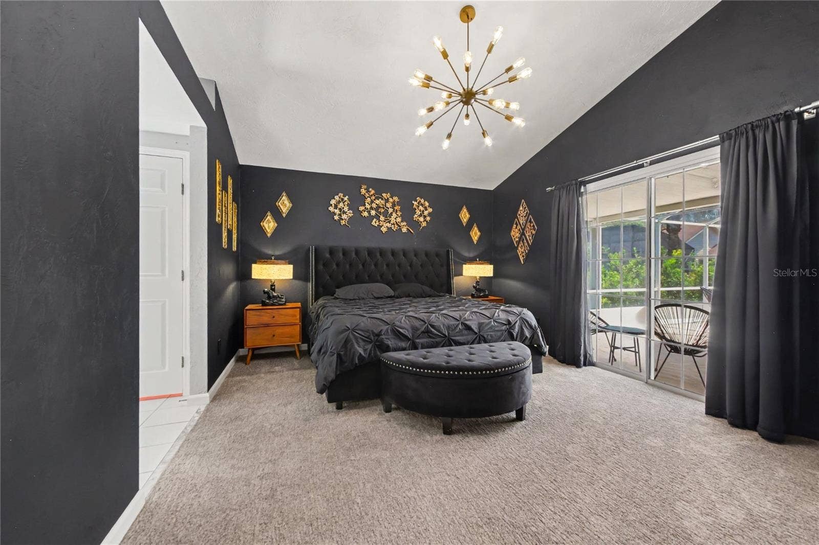 2013 BEAVER CREEK DRIVE, Port Orange, FL 32128 The primary suite features vaulted ceilings and sliding glass doors that open directly to the pool area.