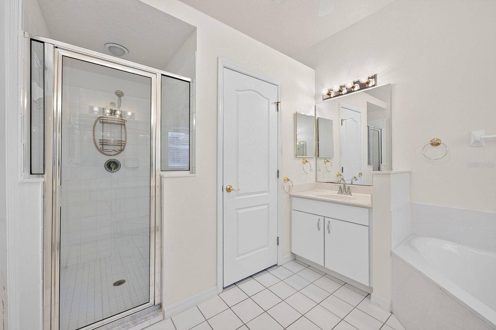 The PRIVATE EN SUITE BATH features dual vanities, a relaxing garden tub, a separate step-in shower with a NEWER LIGHT (2023), and a private water closet.