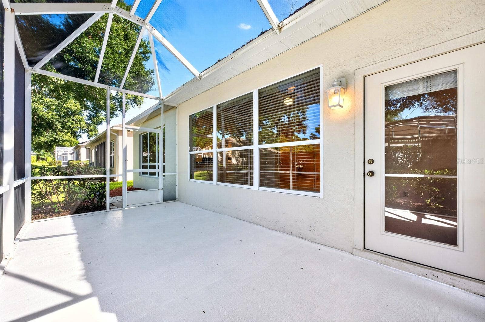 Step through a door in the Sunroom to the back patio under a screened lanai.