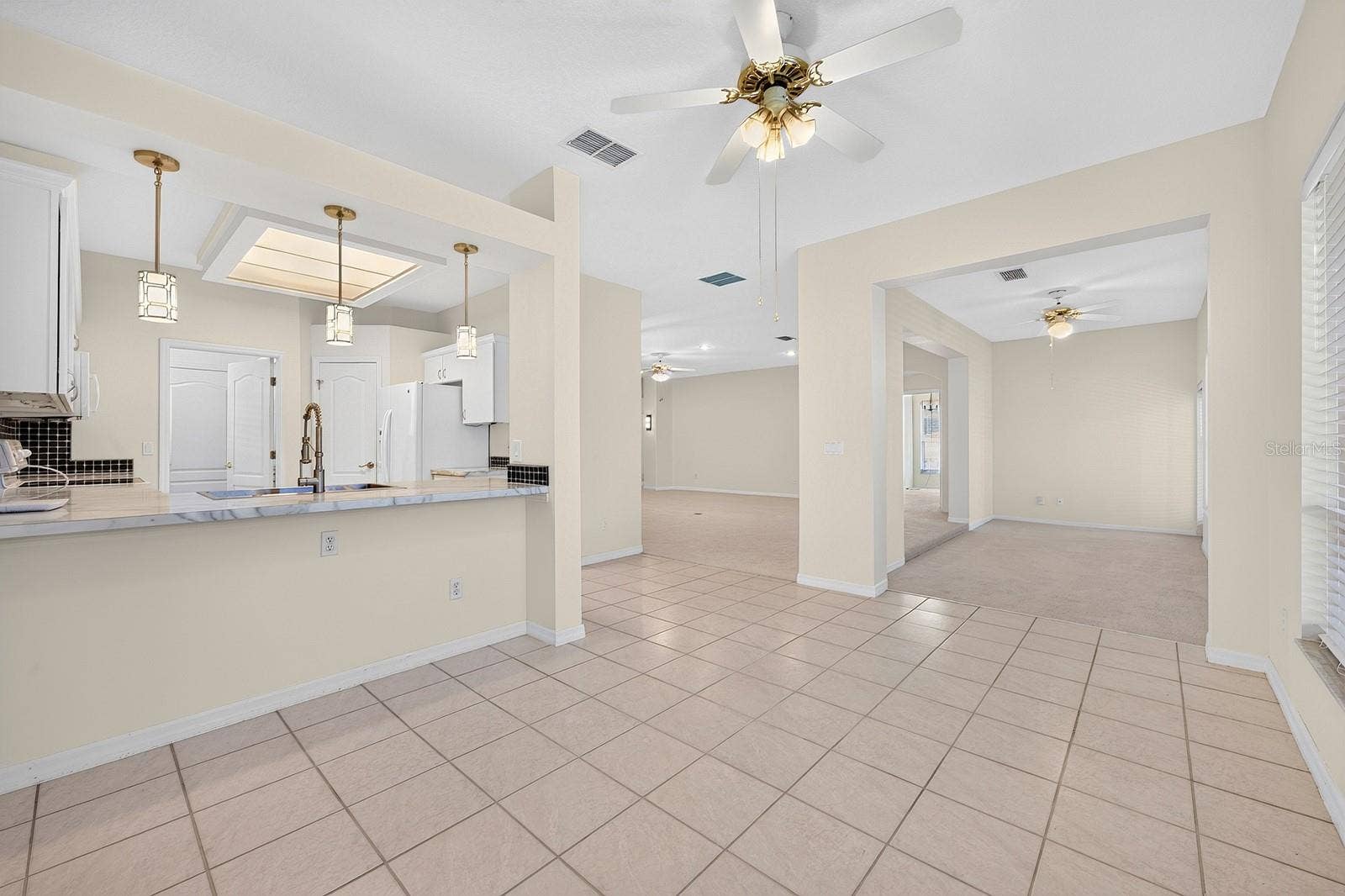 A BREAKFAST BAR creates a natural gathering spot, while the WALK-IN PANTRY provides convenient storage.
