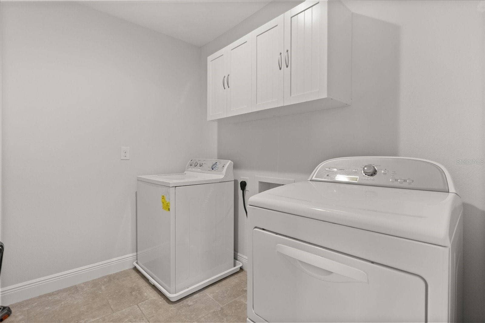 16124 AZURE KEY STREET, Winter Garden, FL 34787 Nice size laundry room upstairs near bedrooms with added cabinets for storage