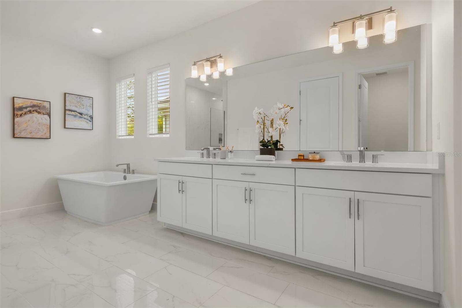 14360 CREST PALM AVENUE, Windermere, FL 34786 Luxurious primary bathroom with shower, dual vanity, soaker tub, and water closet
