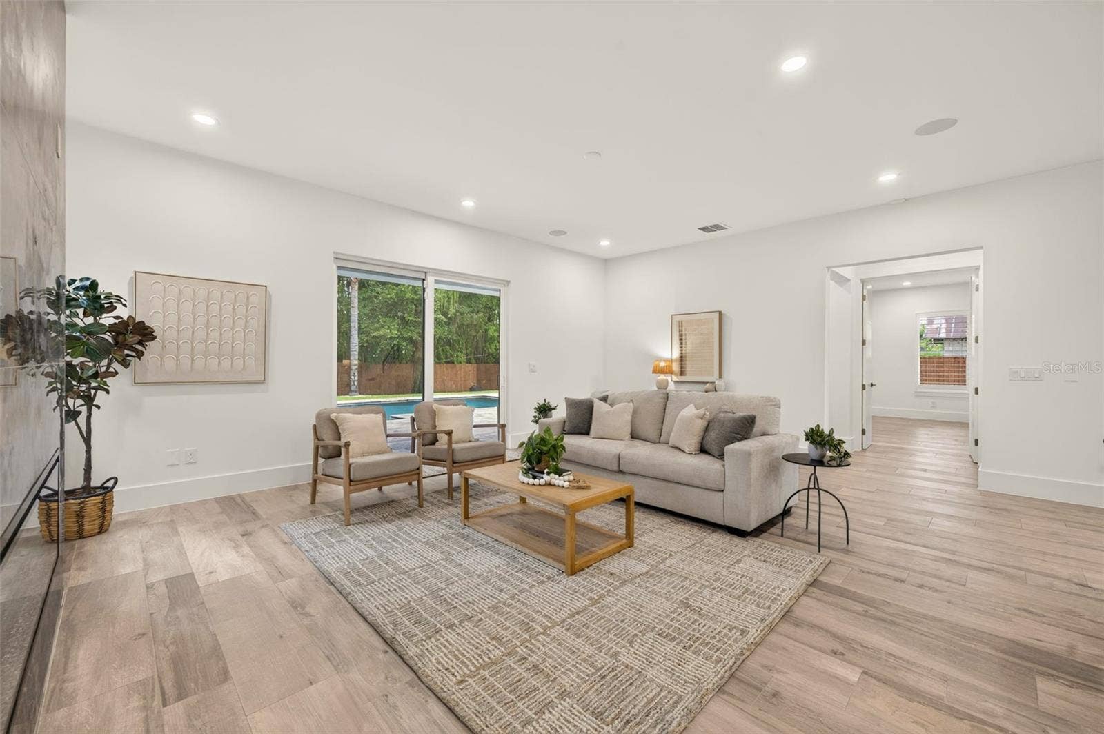 Living room with sliding glass doors to the covered lanai & pool