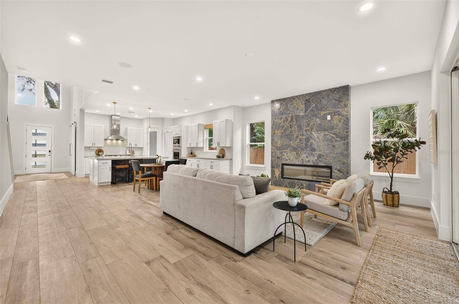 Washed oak porcelain plank tile flooring throughout the 1st floor