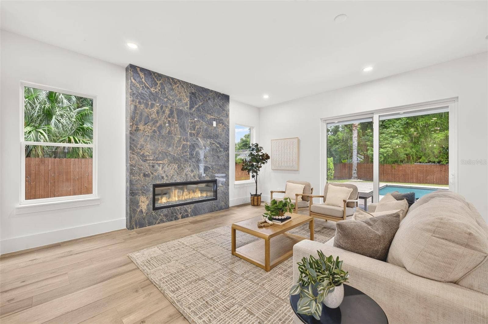 Living room with custom-built fireplace & stylish tile surround