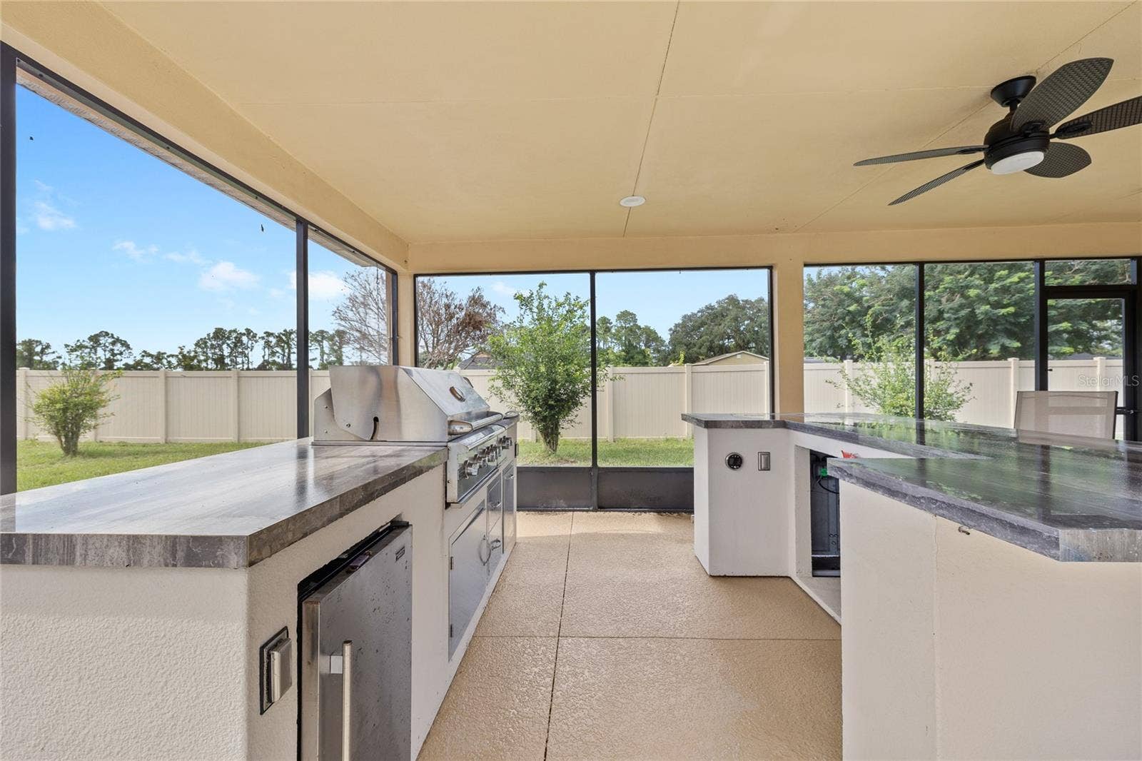 12901 PHILLIPS ROAD, Groveland, FL 34736 Summer kitchen. Propane grill and refrigerator