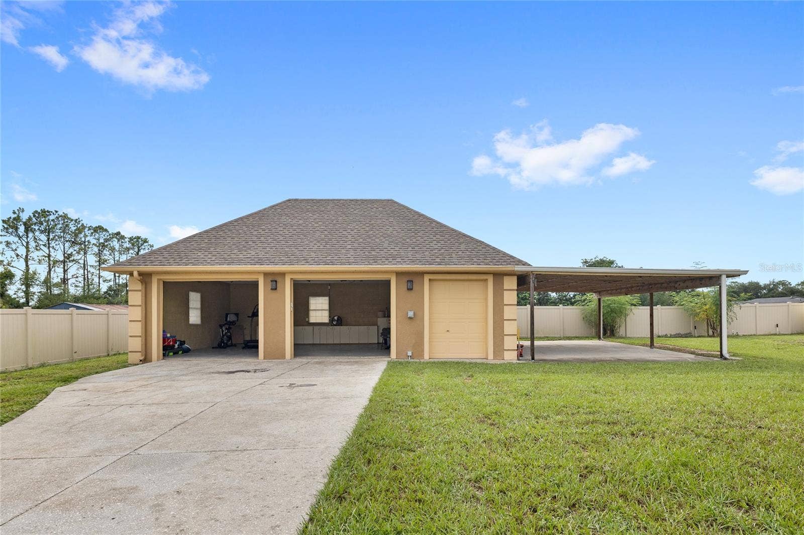 12901 PHILLIPS ROAD, Groveland, FL 34736 Detached two car garage with storage room and carport