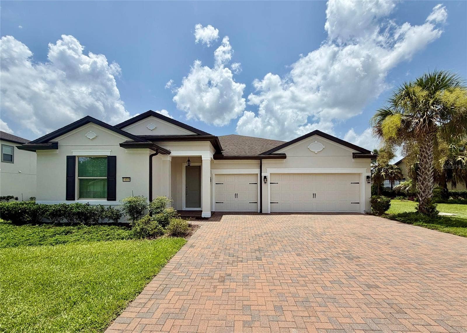 14048 LARKSPUR LAKE DRIVE, Winter Garden, FL 34787 14048 Larkspur Lake Dr - Front exterior with three-car garage and spacious driveway.