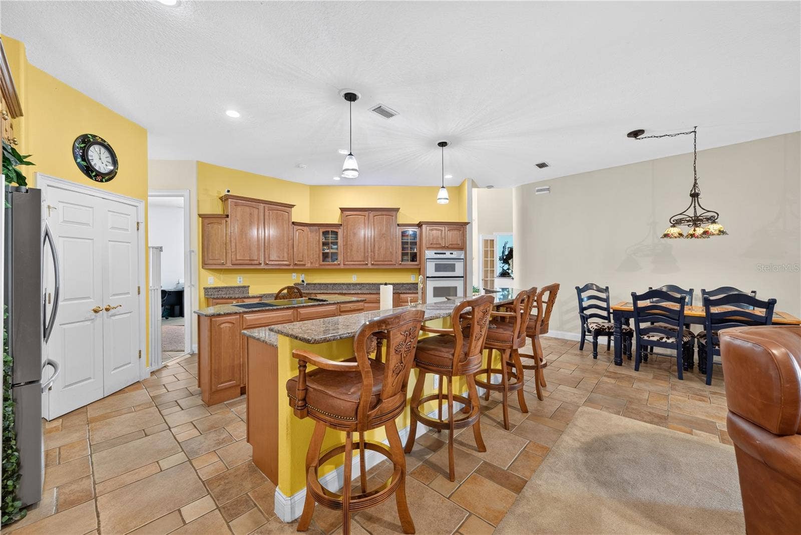 2335 FOREST CLUB DRIVE, Orlando, FL 32804 Kitchen with walk-in pantry, cooking island, bar seating and an abundance of cabinetry.