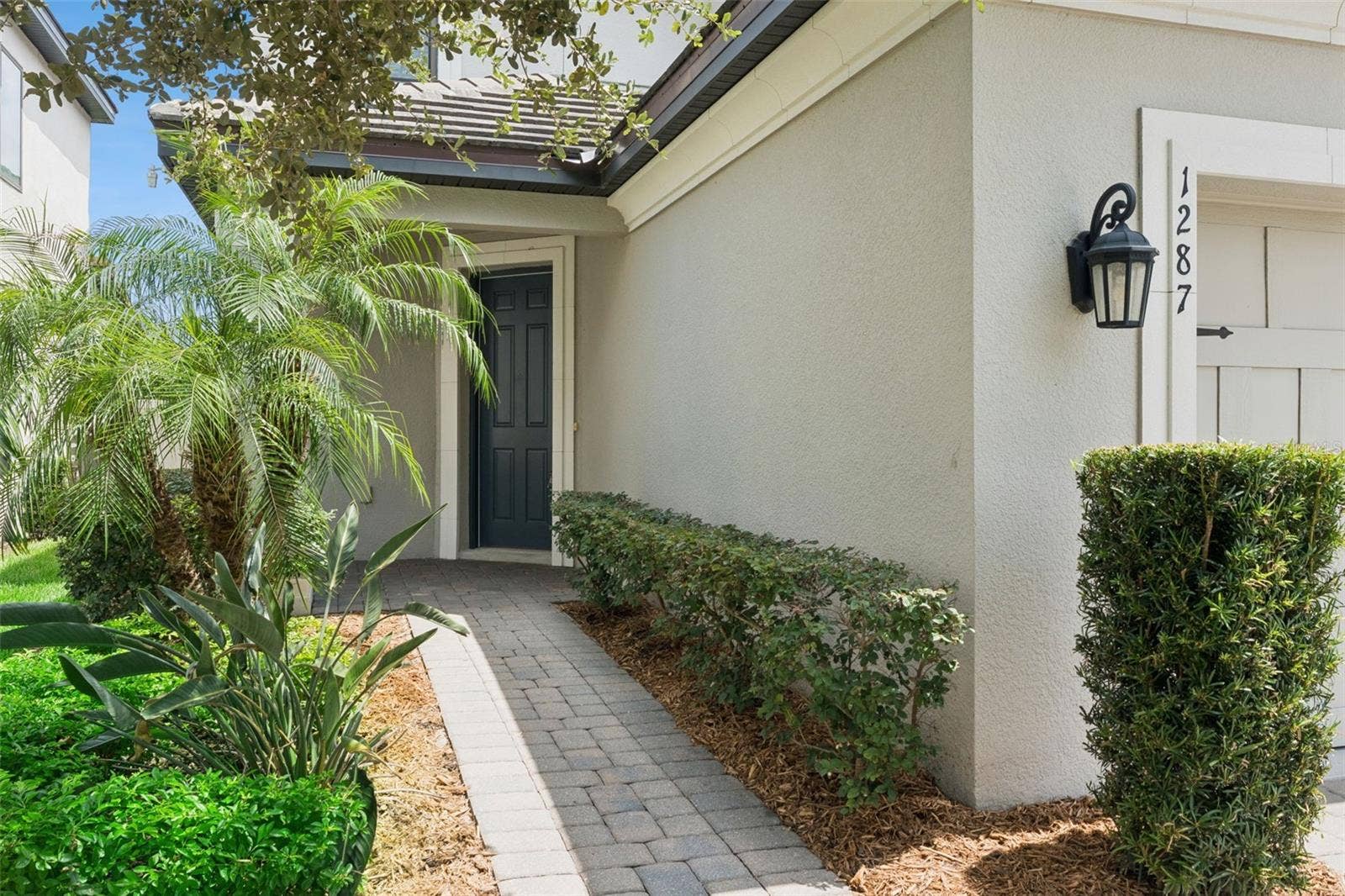 Front Entry  A landscaped paver walkway leads to the covered front entry, creating an inviting approach to the home.