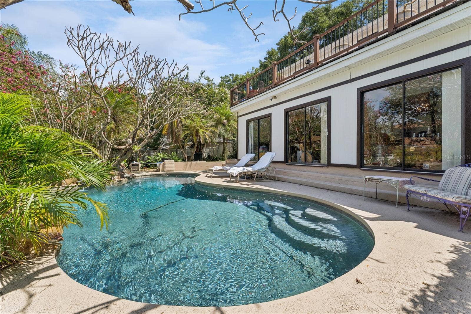 Game room and bar with three sliding glass doors offering panoramic views of your private oasis