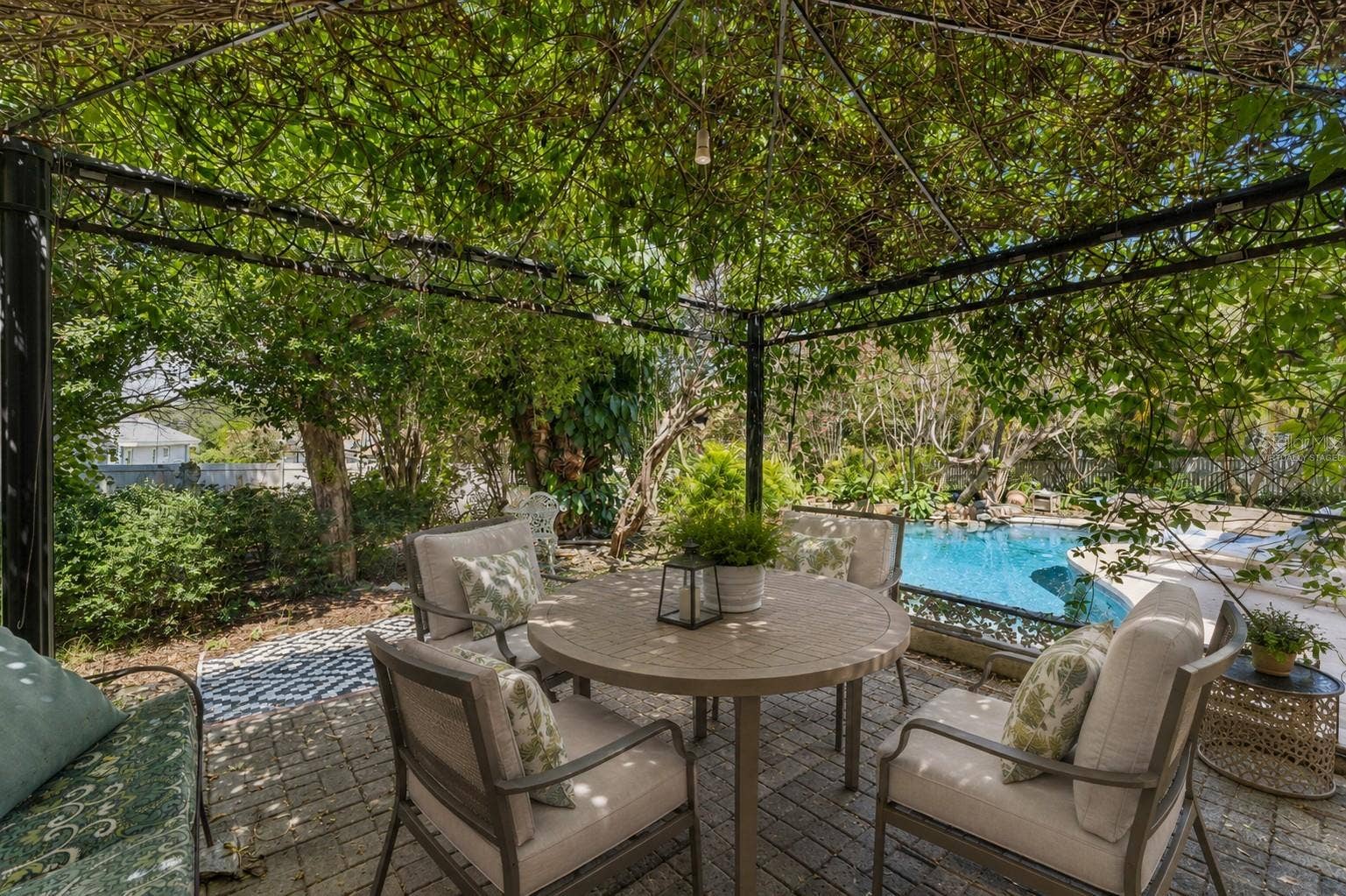Virtually Staged. Naturally covered patio area overlooking your private pool.