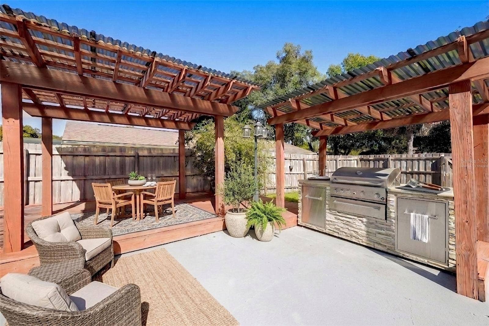 954 NIBLICK DRIVE, Casselberry, FL 32707 Outdoor pergola and grilling area - virtually staged