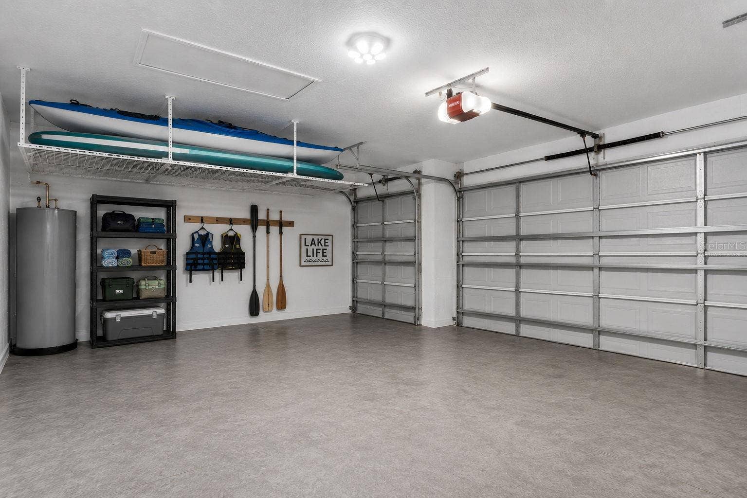 589 BLUE CYPRESS DRIVE, Groveland, FL 34736 Virtually Staged. Ample space to store your kayak, canoe and lake gear in your 3 car garage.