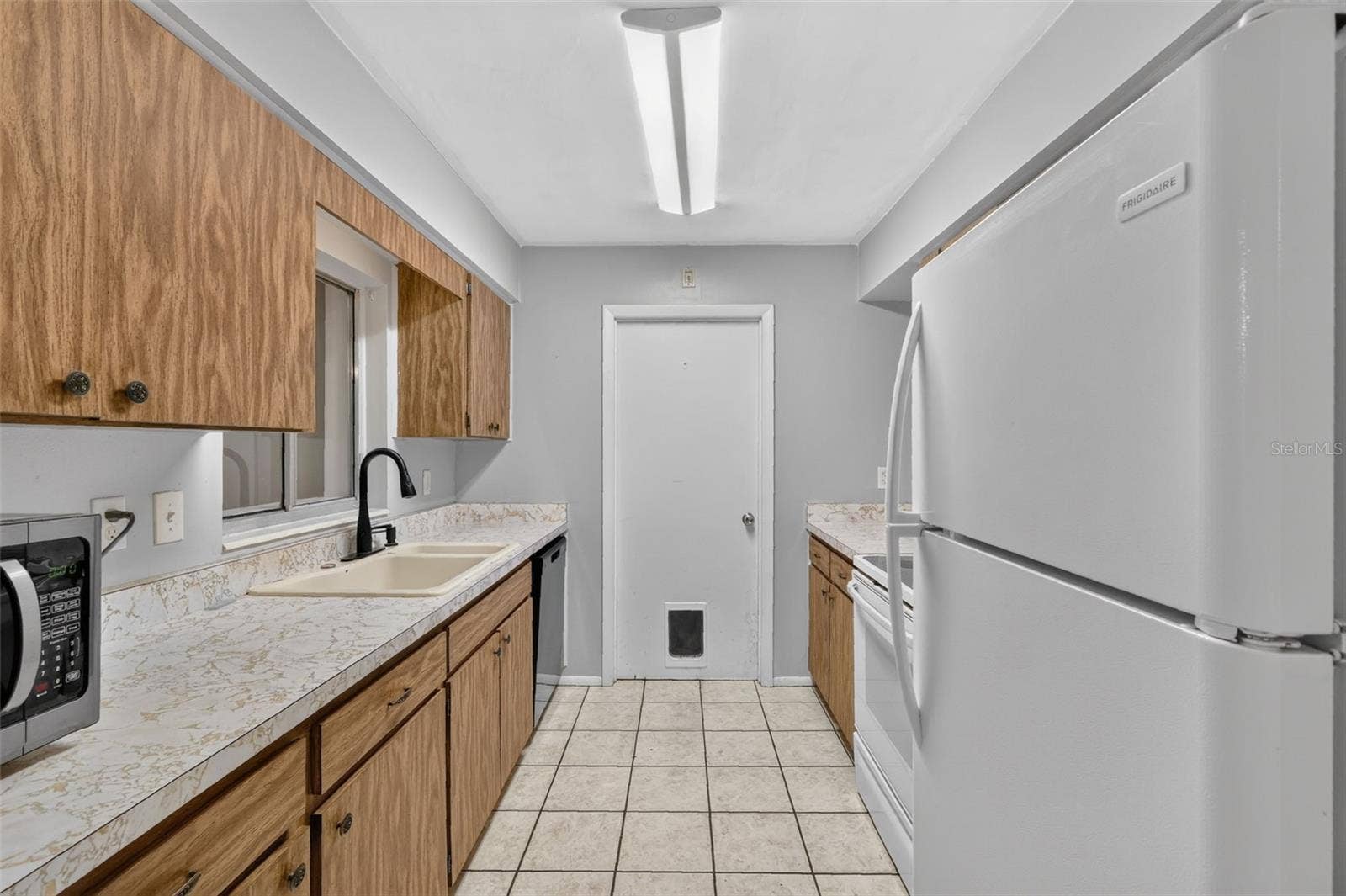 1305 ORANGE AVENUE, Tavares, FL 32778 Galley-style Kitchen with Ample Cabinet and Counter Space
