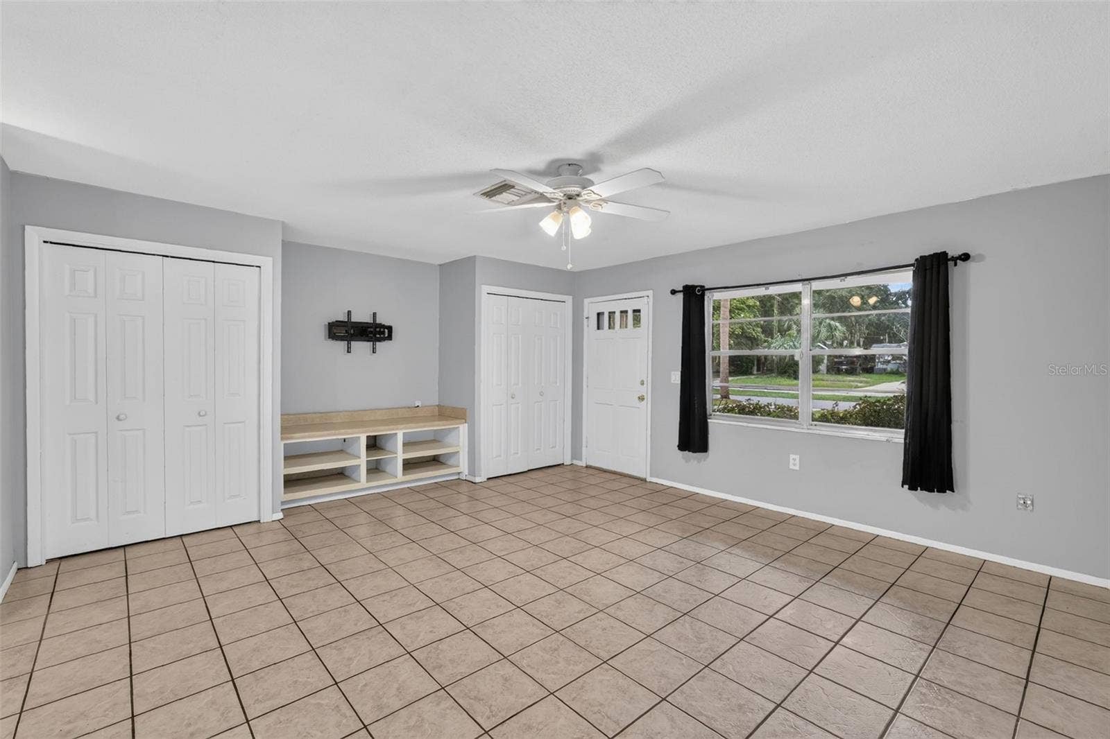 1305 ORANGE AVENUE, Tavares, FL 32778 Light Filled Living Area With Neutral Paint and Tile Flooring