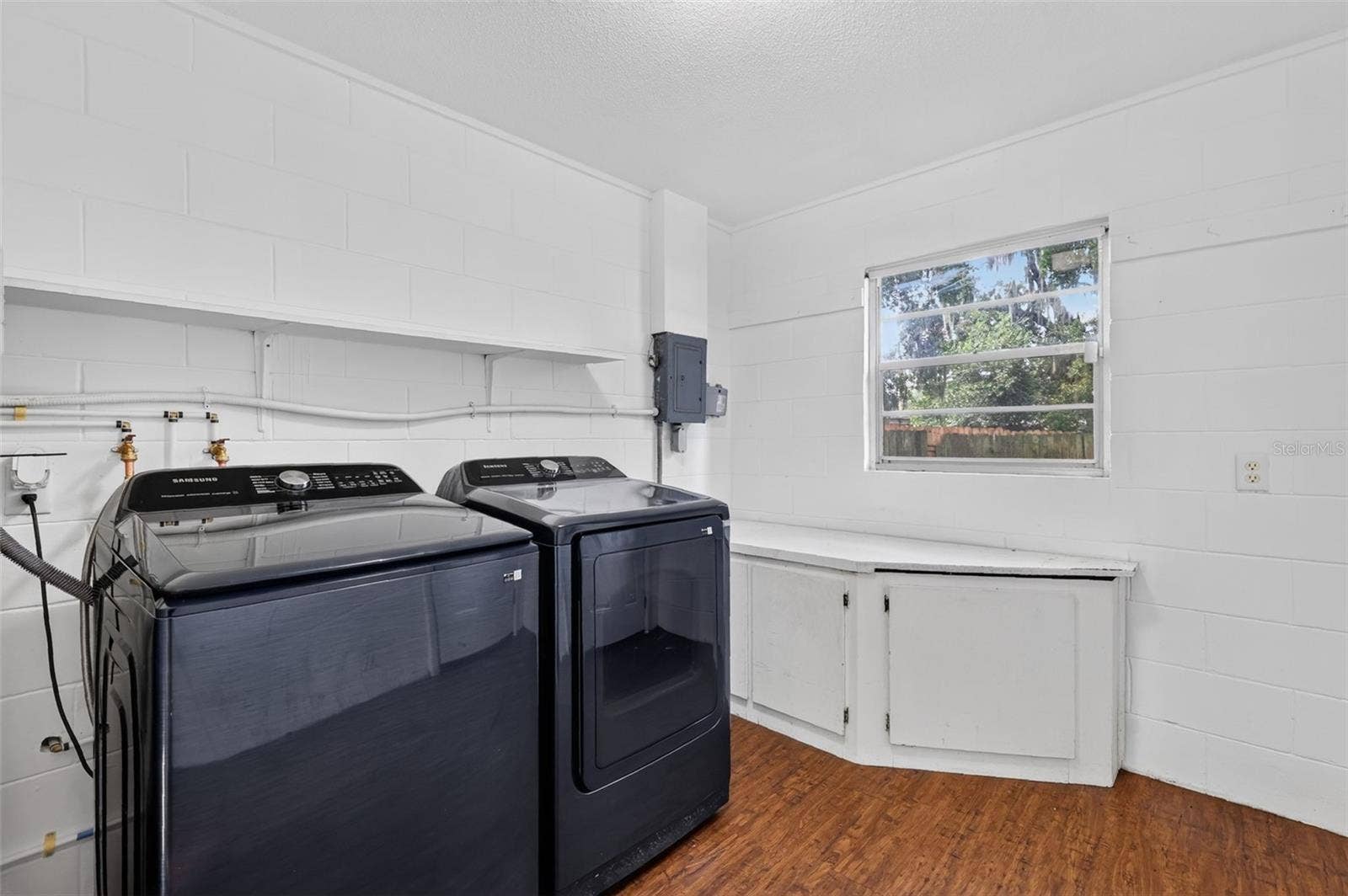 1305 ORANGE AVENUE, Tavares, FL 32778 Nice Sized Utility/Laundry Room with Built-in Cabinetry and Storage-Samsung Washer and Dryer Included!