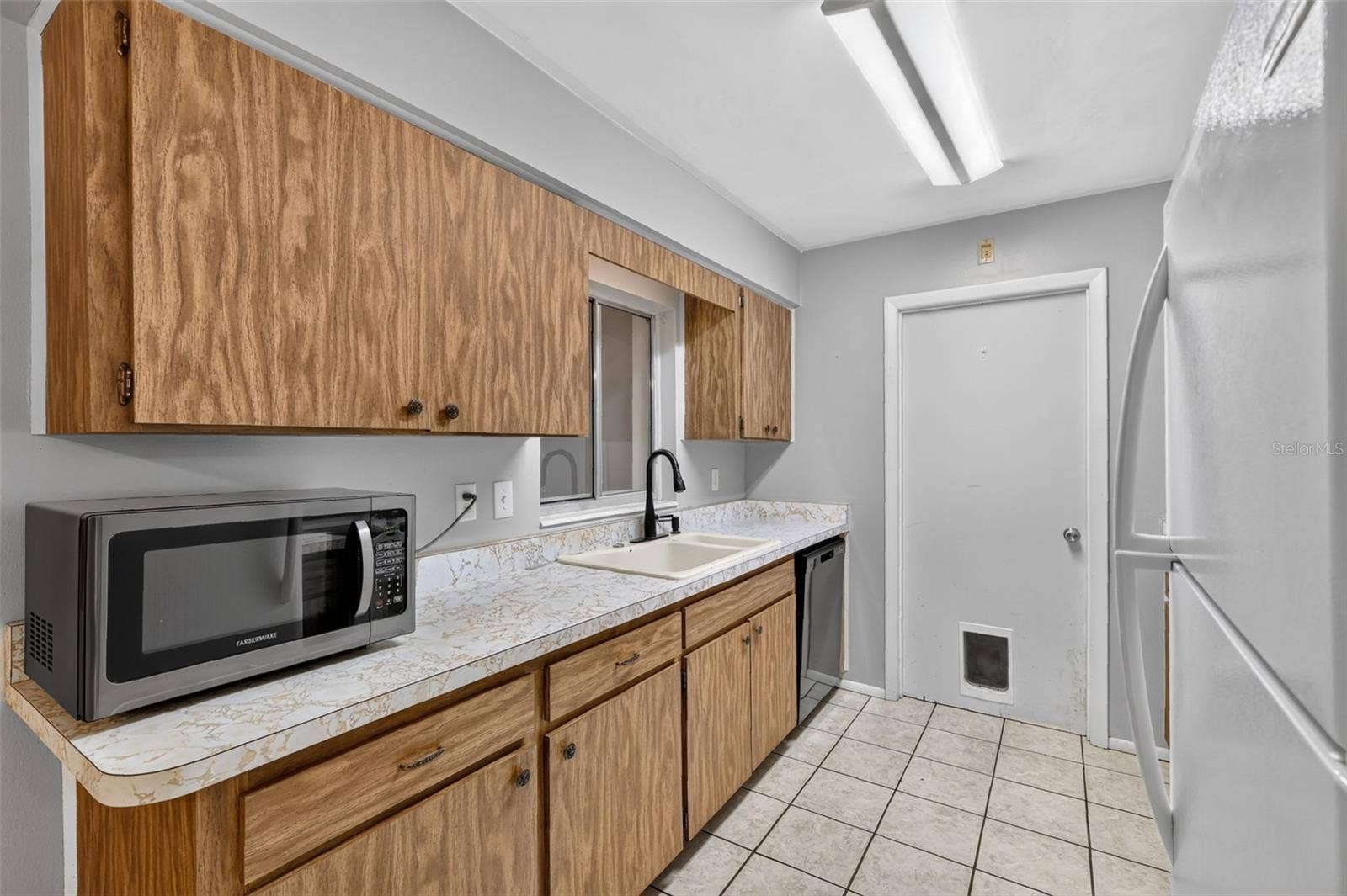 1305 ORANGE AVENUE, Tavares, FL 32778 Easy Access To Laundry/Utility Room from Kitchen