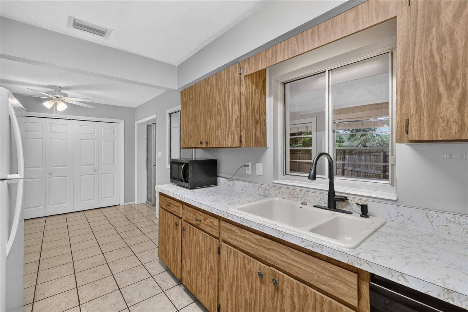 1305 ORANGE AVENUE, Tavares, FL 32778 Dining Area Conveniently Located Next to Kitchen-Window View/Access Into Florida Room From Kitchen