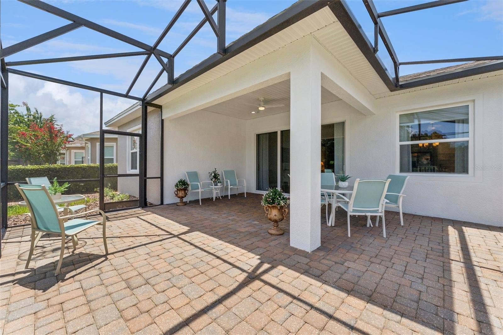 Screen enclosed covered lanai w/ brick pavers, ceiling fan & recessed lighting