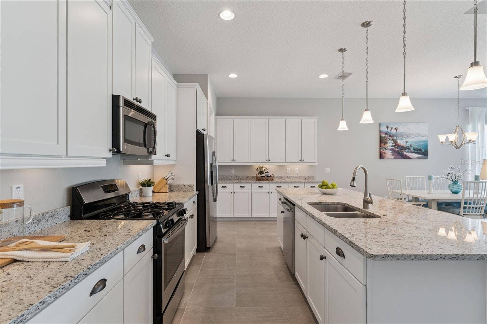 Kitchen w/ 42" wood cabinets, under cabinet lighting, 4-burner natural gas range & stainless steel appliances