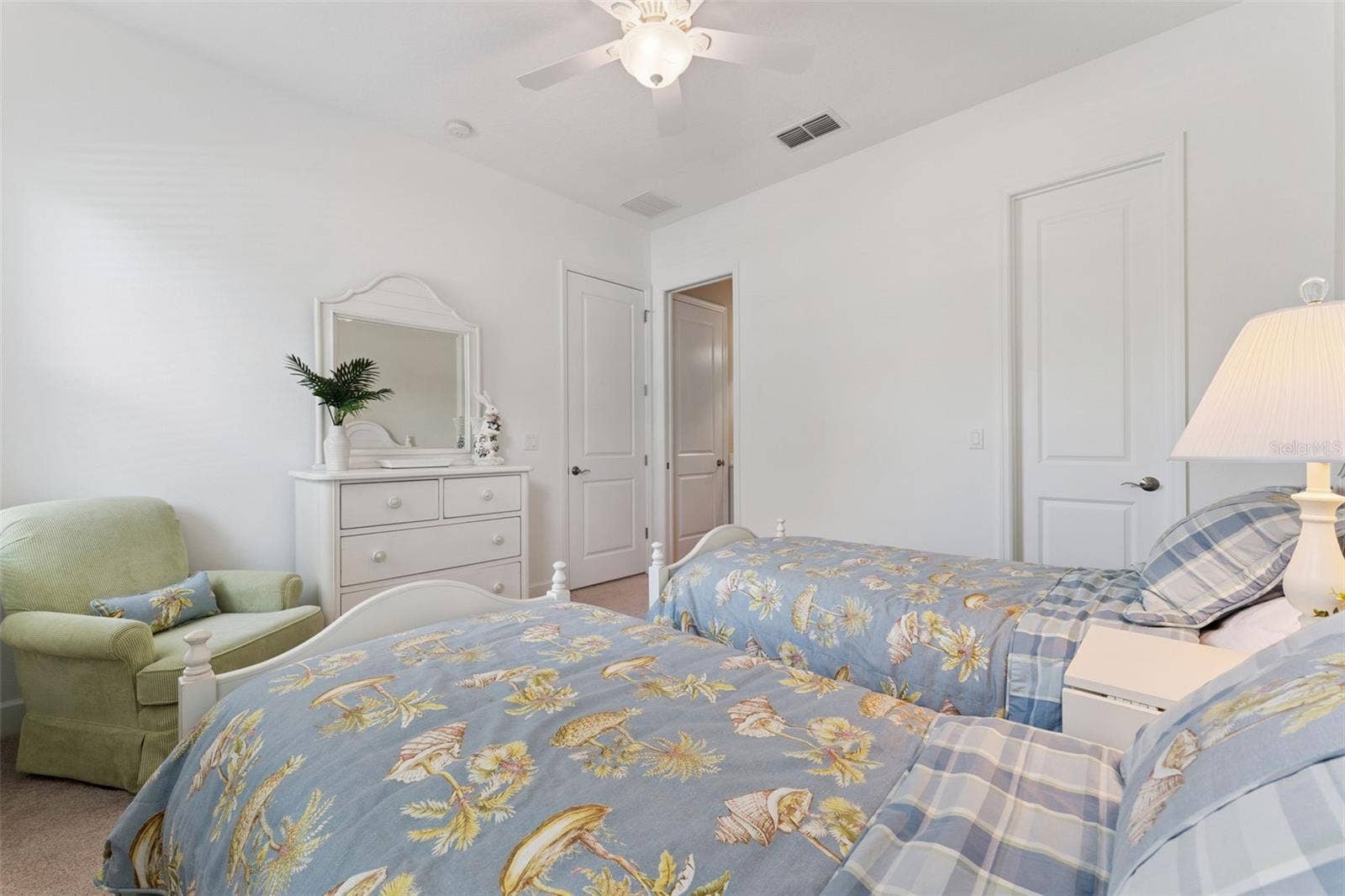 Bedroom #2 w/ a pocket door entry into the guest bathroom offering flexibility to function as an en suite