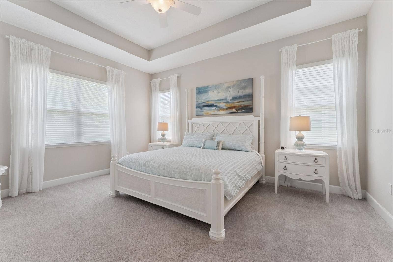 14' x 17' Primary Bedroom w/ tray ceiling, ceiling fan & remote controlled sheer shades