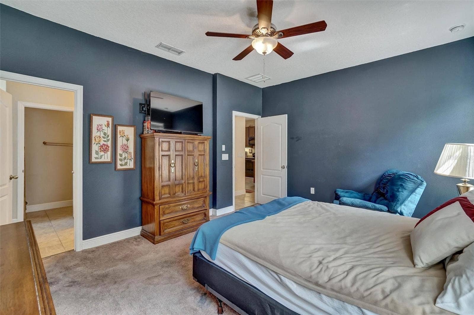 Bedroom ViewComfortable primary bedroom featuring a ceiling fan and ample storage.