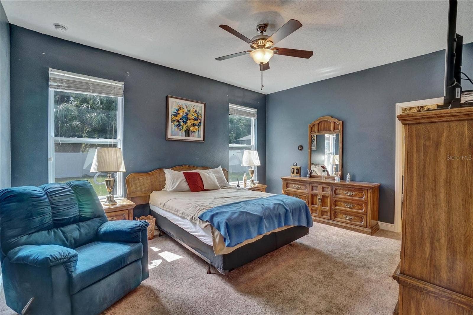 Primary BedroomSpacious primary bedroom with ceiling fan, and abundant natural light.