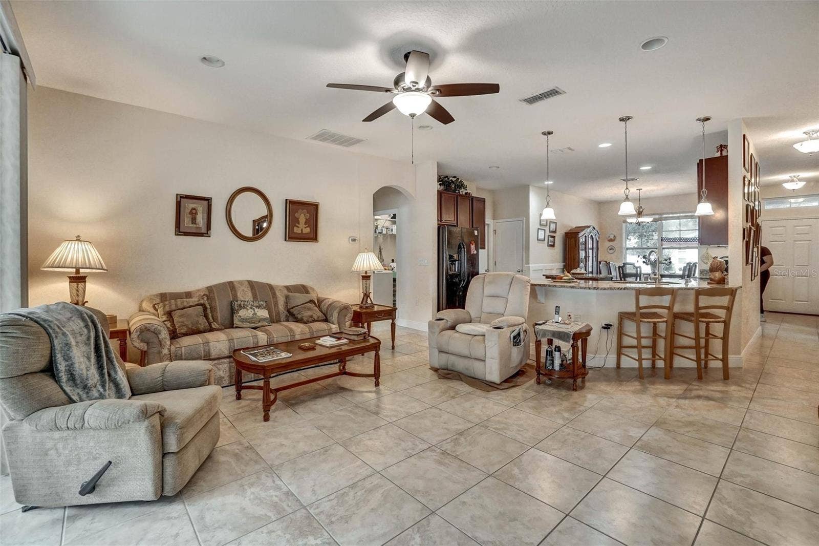 Open living area with comfortable seating and a seamless dinning room and kitchen connection