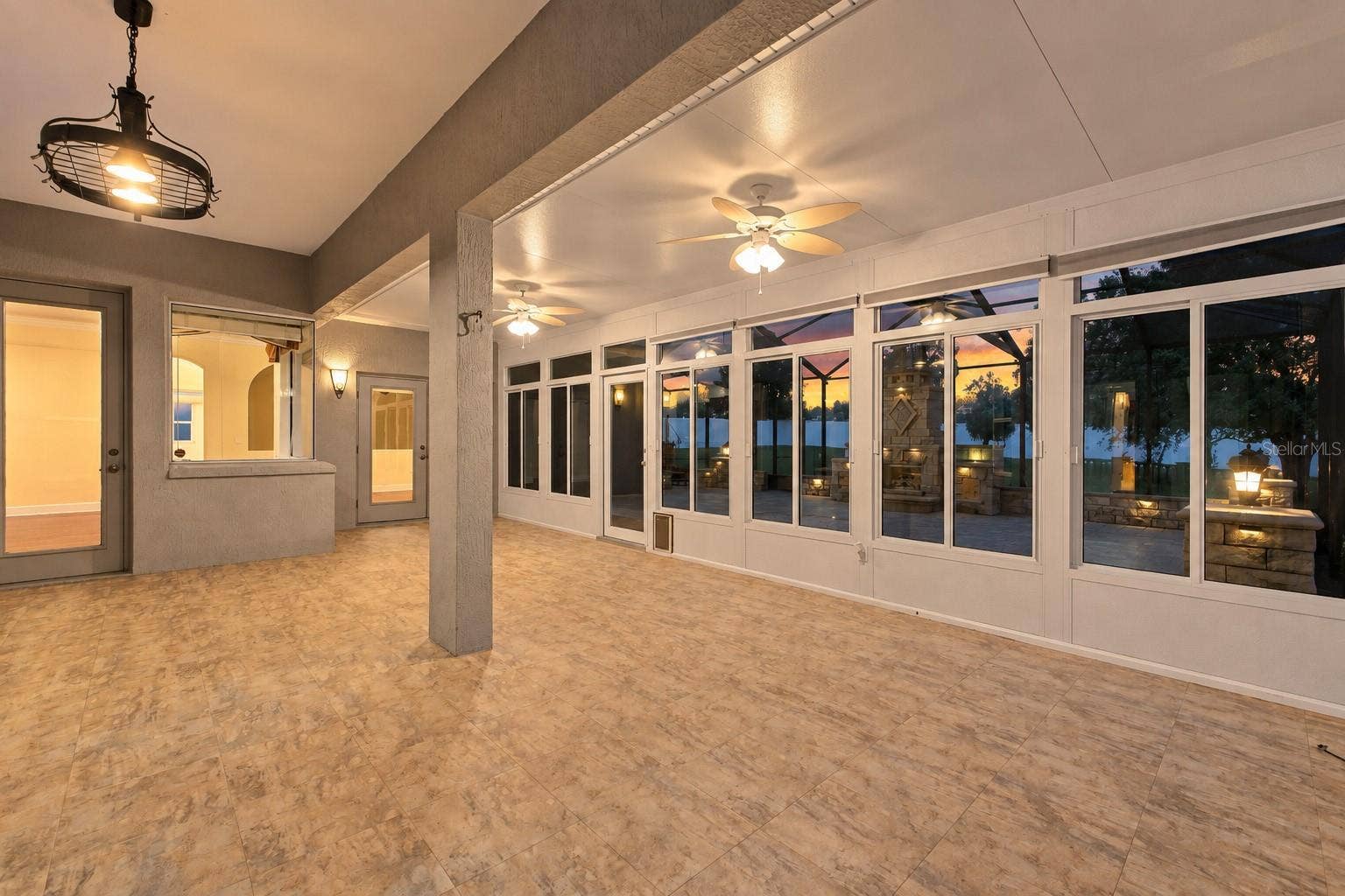 230 LAKE ARIETTA COURT, Auburndale, FL 33823 enclosed porch at twilight