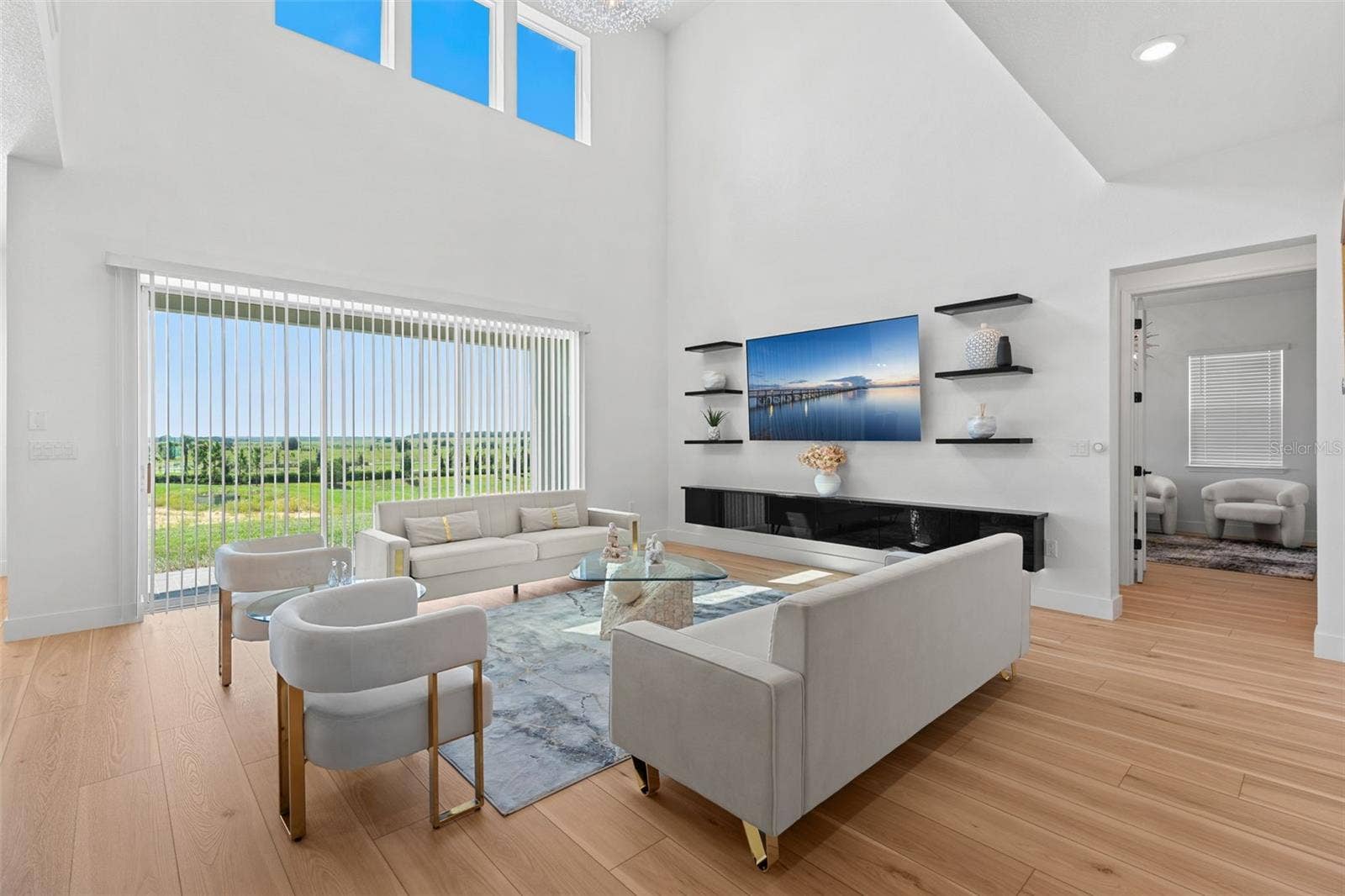 4617 GOLDEN BIRCH AVENUE, Clermont, FL 34714 A wall of sliding glass doors let the natural light pour in.