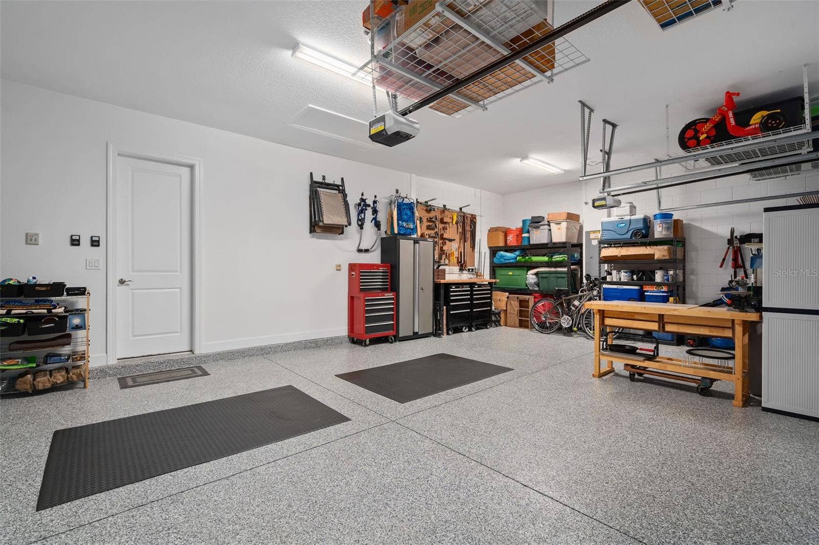 1279 ZEEK RIDGE STREET, Clermont, FL 34715 This full 3 car garage with a "Shark Coating" floor, Insulated garage doors and ceiling storage.